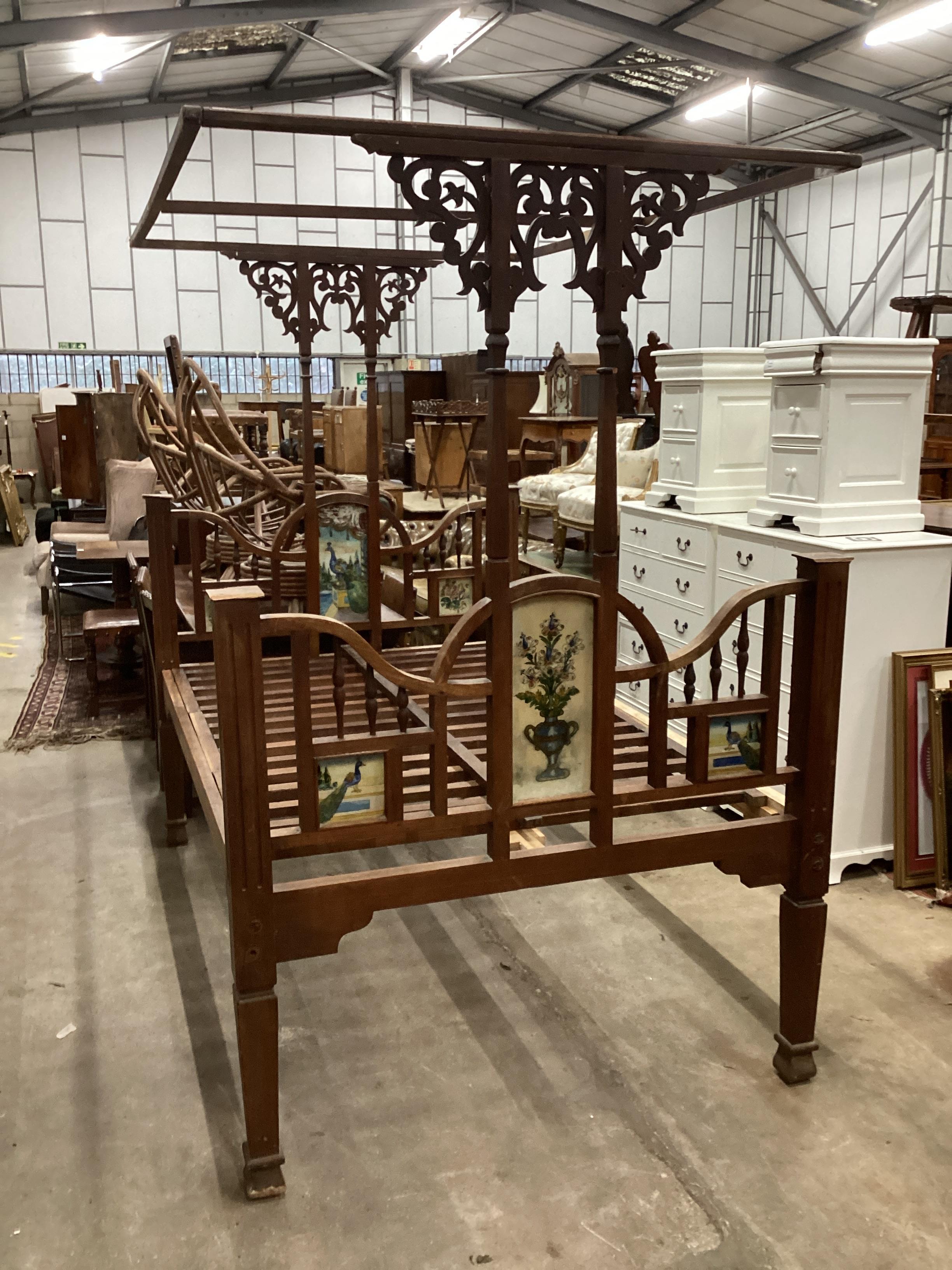 A 19th century Zanzibar hardwood bedframe inset reverse painted glass panels of peacocks and vases of flowers, length 210cm, width 140cm, height 215cm